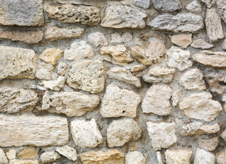 Stones in the wall of the house as an abstract background.