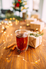 Glass mug of tea with star anise and garland light