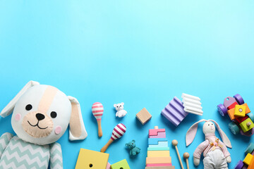 Flat lay composition with different toys on light blue background. Space for text