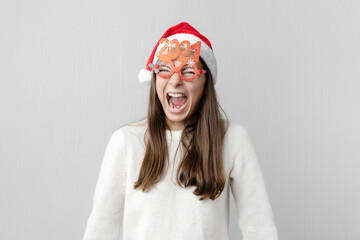 Woman with santa hat and 2021 glasses. New year, christmas holiday.