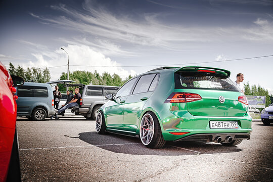 Moscow, Russia - July 06, 2019: Tuned Golf 7 tightened into a green vinyl film. Installed exclusive wheels, air suspension. Lowrider in the parking lot. Back side view