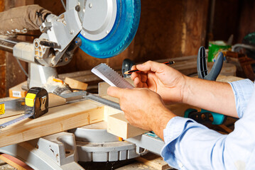Carpenter work with circular saw for cutting wood bar, the man sawed bars, construction and home renovation. Carpenter work concept