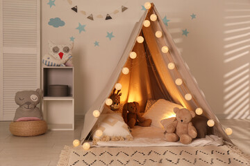 Modern children's room interior with play tent and lights © New Africa