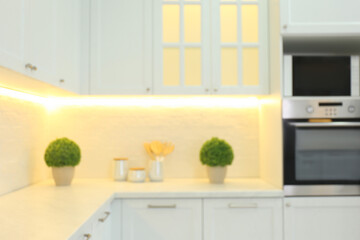 Blurred view of modern kitchen interior with stylish furniture
