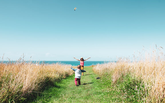 Mom and child playing around fields in Kaiokura, New Zealand.