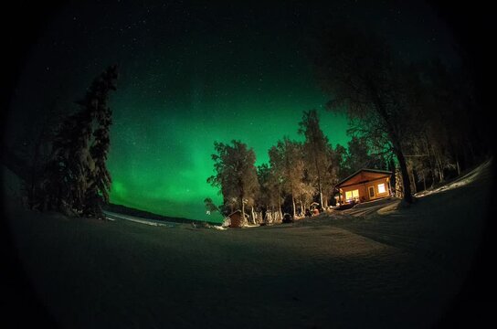 Aurora over cabin in Alaska