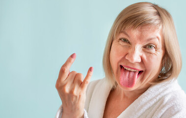 Funny crazy cheerful senior woman funky tongue out. Concept of old age in joy, about seniority, cutie grandmother. Anti age, healthcare and cosmetology, pensioner and mature people, new senior