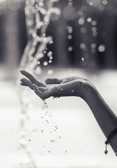 beautiful hand under rain,drops of water,black and white style,closeup
