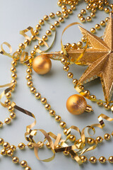golden christmas decorations on blue background greeting card.