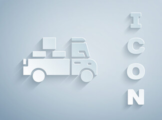 Paper cut Delivery truck with cardboard boxes behind icon isolated on grey background. Paper art style. Vector.