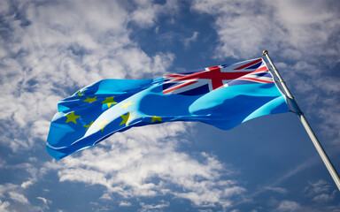 Beautiful national state flag of Tuvalu fluttering at sky background. Low angle close-up Tuvalu...