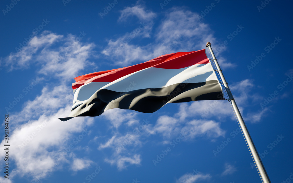 Wall mural beautiful national state flag of yemen fluttering at sky background. low angle close-up yemen flag 3