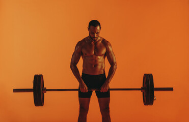 Fototapeta na wymiar Bodybuilder lifting barbell