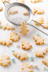 Homemade Christmas cookies in Christmas tree shape on marble background
