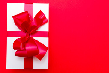 Top view White gift box ribbon flat lay red background.Christmas concept.