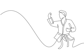 One single line drawing of young sporty karateka man in fight uniform with belt exercising martial art at gym vector illustration. Healthy sport lifestyle concept. Modern continuous line draw design © Simple Line