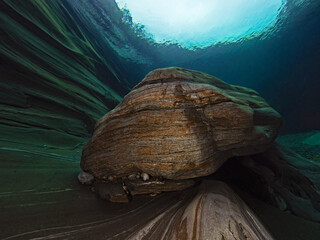 Gneiss rock in the creek bed underwater