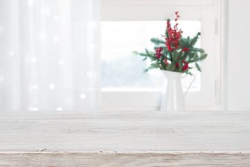 Bleached wooden table for product display on blurred window background