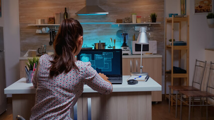 Woman scrolling programming security hacking code data late at night on laptop. Programmer writing...