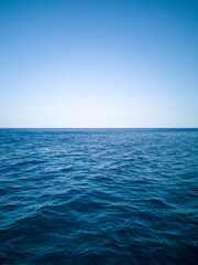 Blue ocean water and sky straight horizon line