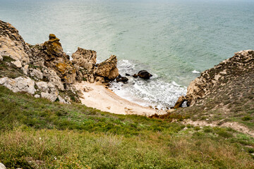 Mountains of steel and stones on the seashore. Wild beach. holidays, privacy,