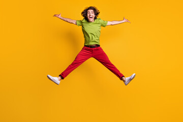 Fototapeta na wymiar Full length body size photo of jumping like star cheerful happy man isolated on bright yellow color background