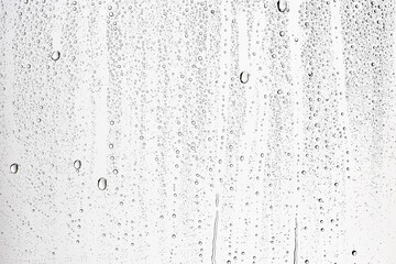Fototapeta na wymiar white isolated background water drops on the glass / wet window glass with splashes and drops of water and lime, texture autumn background