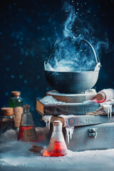 Couldron with winter and snow, witch potion concept, magical still life with