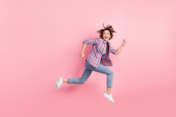 Full length photo of purposeful pretty young lady dressed plaid shirt running quick hands arms fists isolated pink color background