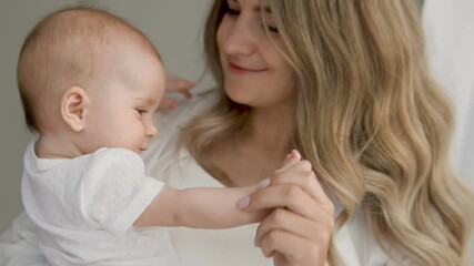 Mum expressing most tenderness, gratitude to life kissing calm angelic toddler