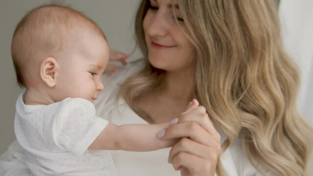 Mum expressing most tenderness, gratitude to life kissing calm angelic toddler