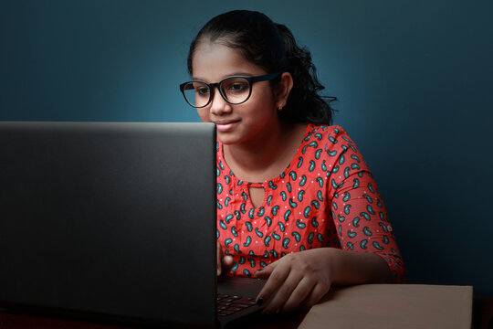 Young Girl Of Indian Origin Learning Through Laptop