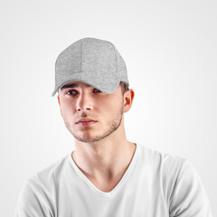 Mockup of gray baseball cap heather on a guy's head, isolated on background.