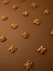 Fototapeta na wymiar peeled walnuts on brown background