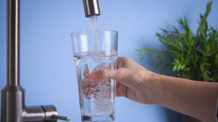 filling tall glass by tap water. Fresh and pure home water, drink water is healthy lifestyle. Ecological and healthy drink