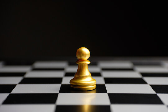 Premium Photo  Closeup of chess pieces on the chessboard under the lights  with a blurry background