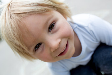 Child, blond boy, playing hopscotch on the street