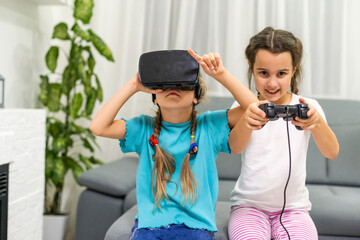 two little girls playing video games virtual reality glasses