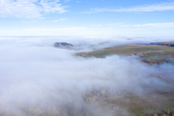 Aerial drone shot of flying above clouds