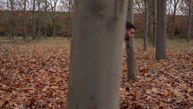 Karate fighter black belt man concentrating and doing a martial bow in the nature in a forest in autumn. Traditional karate wado Ryu