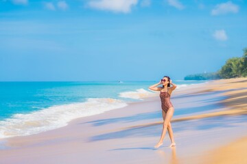 Fototapeta na wymiar Portrait beautiful young asian woman relax smile leisure around sea beach ocean