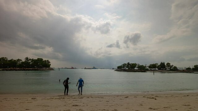 sunny day storm sky singapore city famous sentosa island crowded beach timelapse panorama 4k 