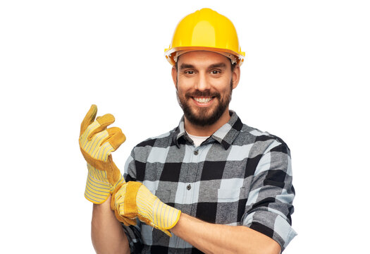 profession, construction and building - happy smiling male worker or builder in helmet and gloves over white background