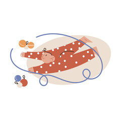 Small child lying on floor and playing with decorative balls for decorating Christmas tree