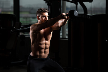 Fototapeta na wymiar Muscular Man Exercising With Kettle-bell