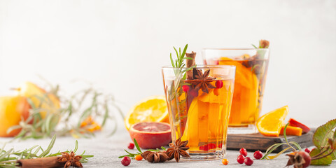 Winter or autumn hot healing tea with pear, orange, lingonberries, sea buckthorn and spices in...