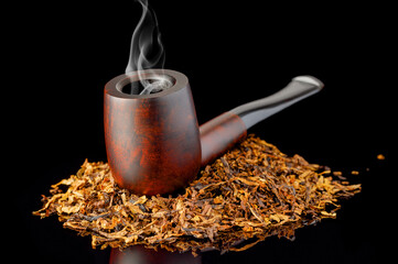 Smoking tobacco pipe with aromatic tobacco on a black background.