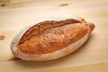 Delicious fresh bread on a wooden table.