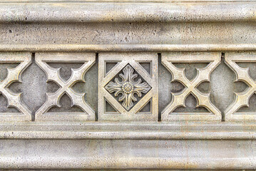fragment of an ornament on a stone, decoration for a stone wall or fence, selective focus
