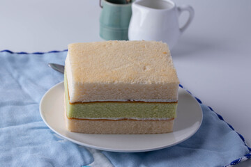 Soft three layers vanilla cake in a white plate